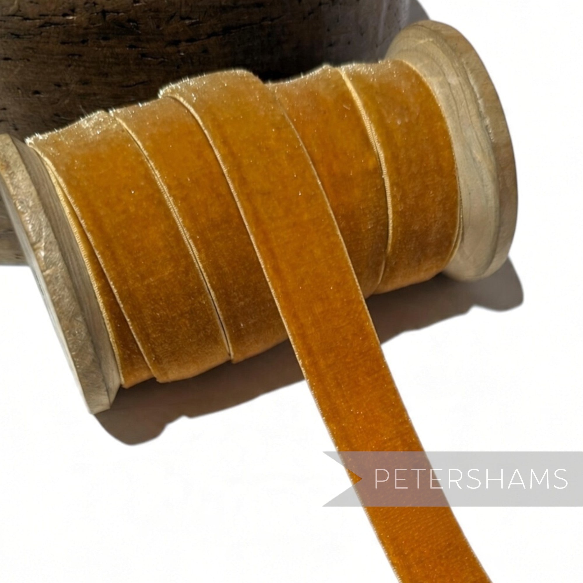 Petershams Millinery Supplies 16mm elastic stretch velvet ribbon in a rich golden mustard colour on a wooden spool