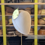 Petershams Millinery Supplies metallic gold foil paper rose leaf trim pinned to a millinery head block