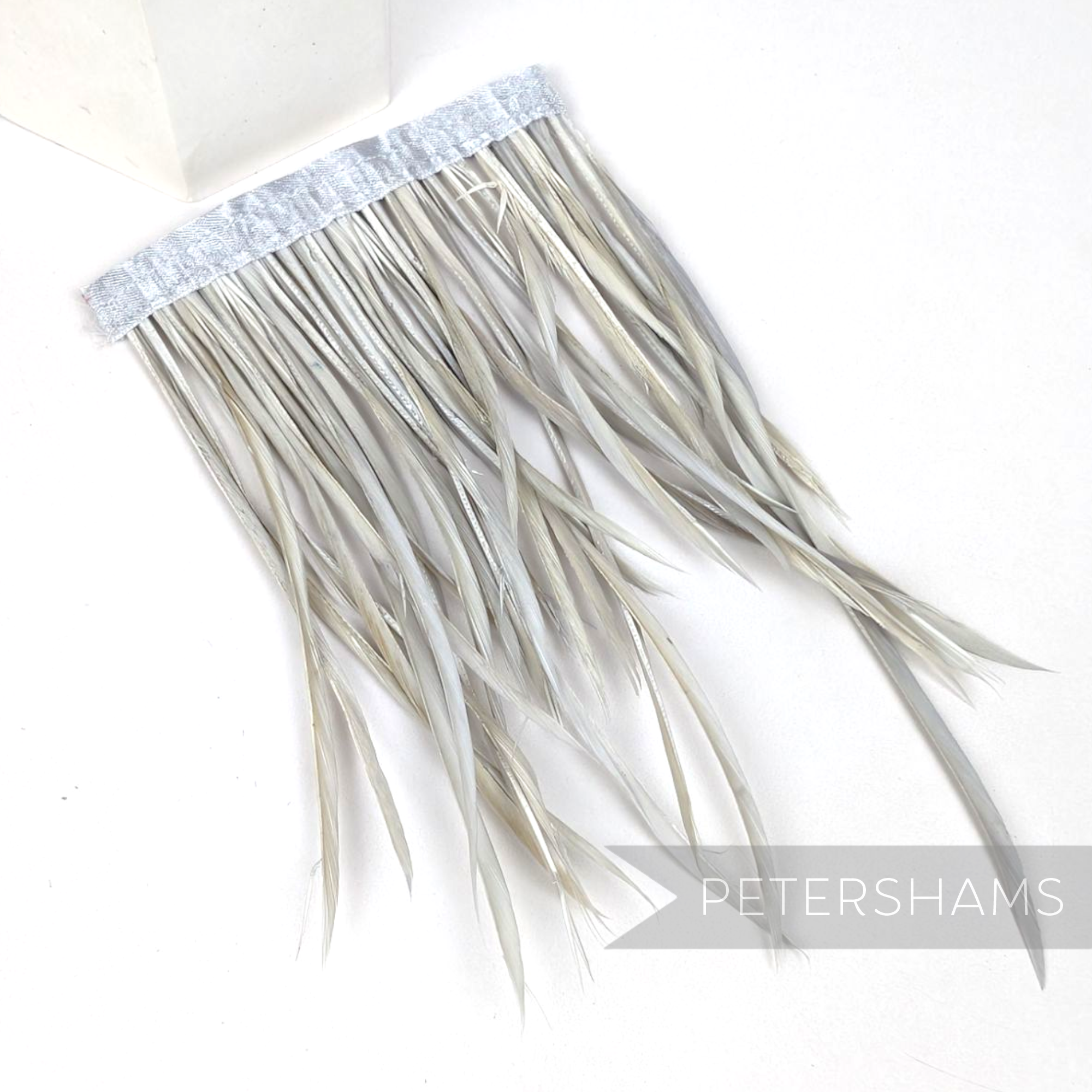 Petershams Millinery Supplies extra long goose biot feather fringe in light grey on a satin ribbon binding