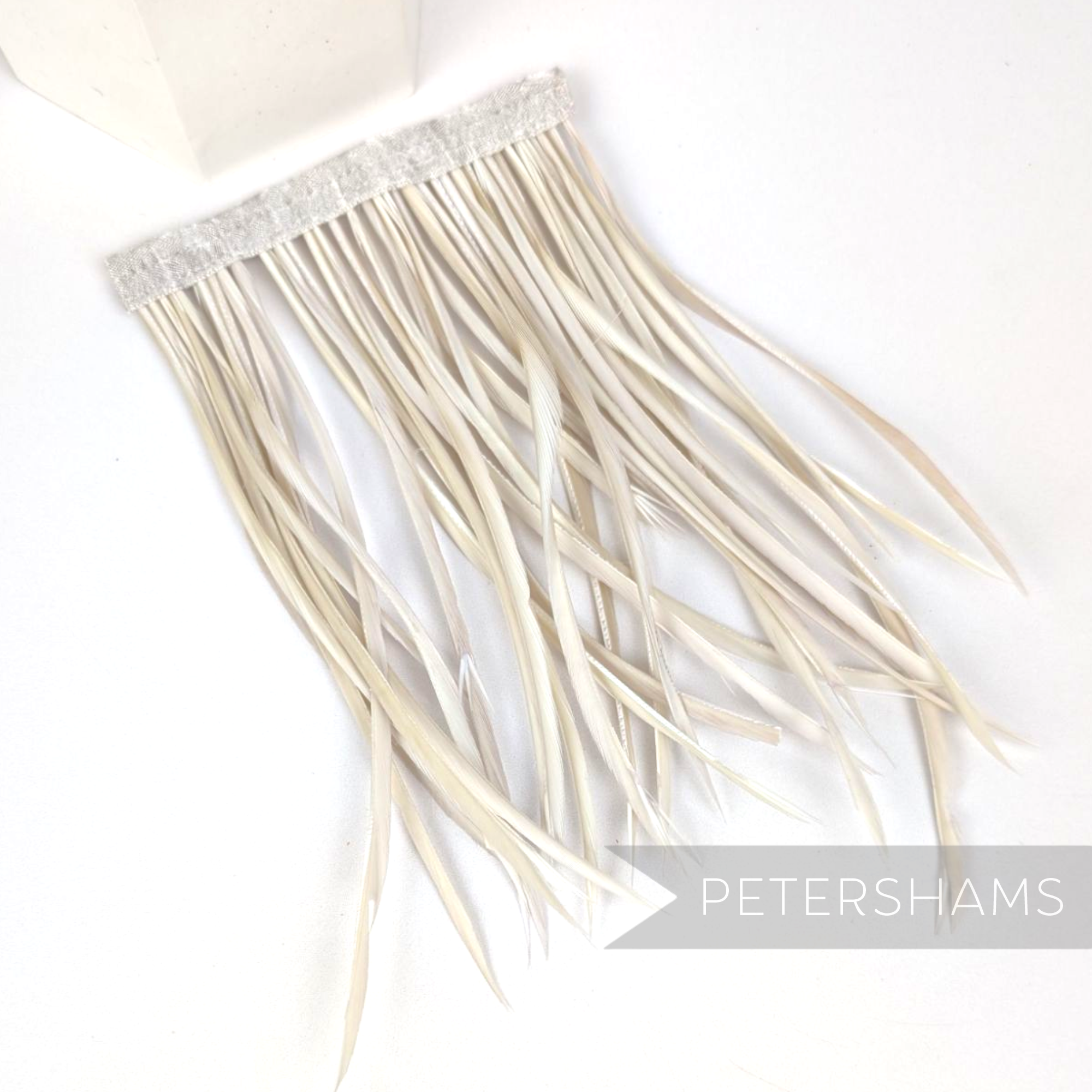 Petershams Millinery Supplies extra long light beige goose biot feather fringe on a stitched satin ribbon binding