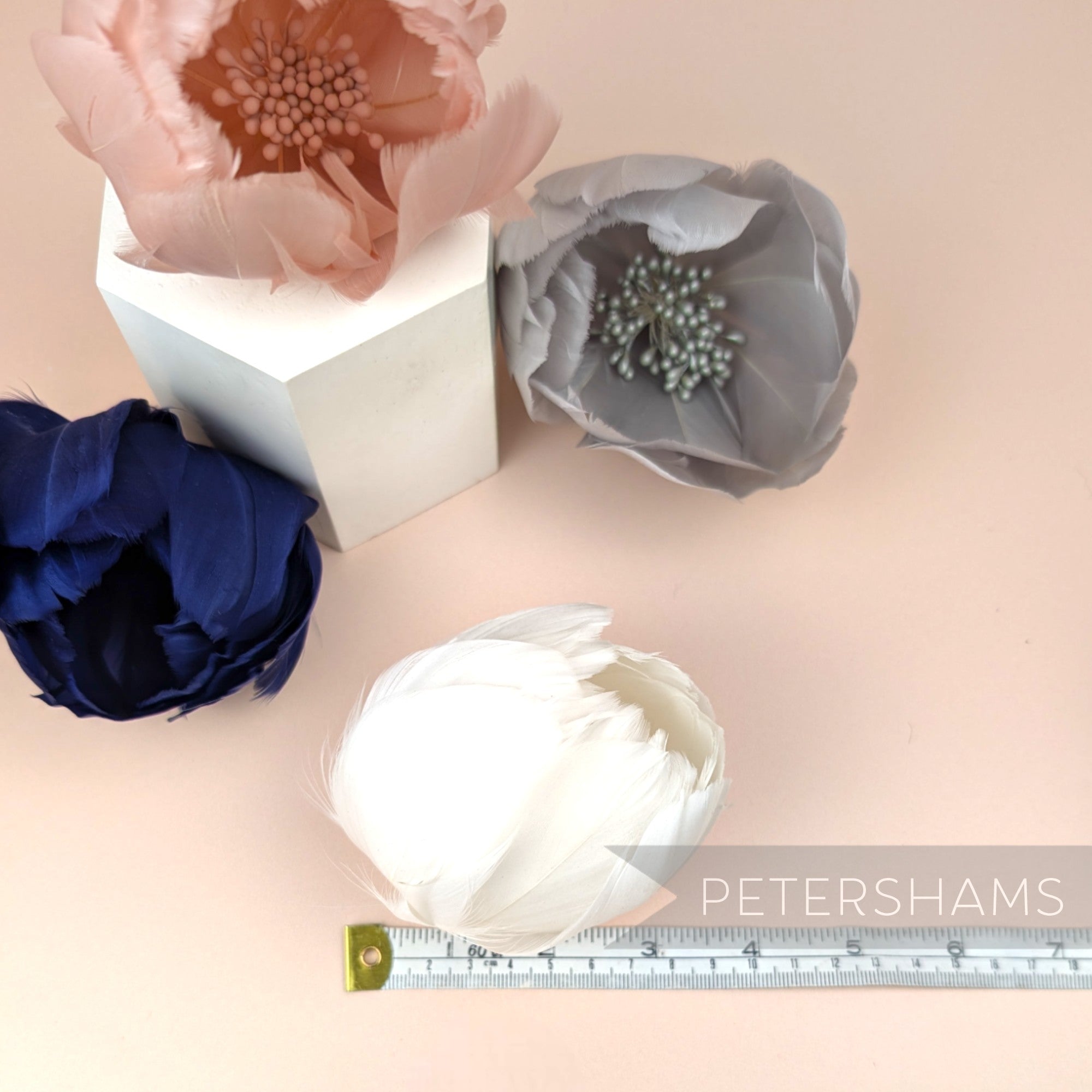 Petershams Millinery Supplies large tulip-shaped goose nagorie feather flowers in pink, grey, navy, and white.