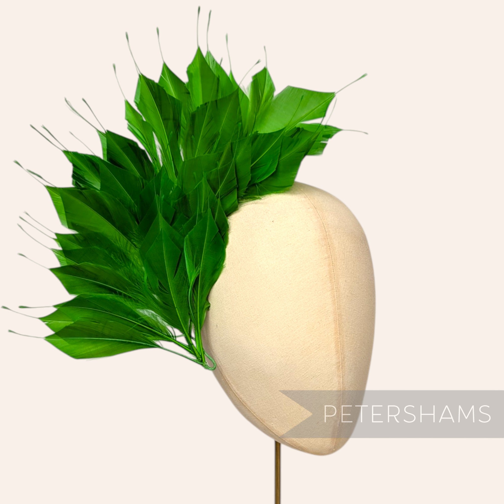 Petershams Millinery Supplies large spiky green goose feather wired hat mount on a millinery display head