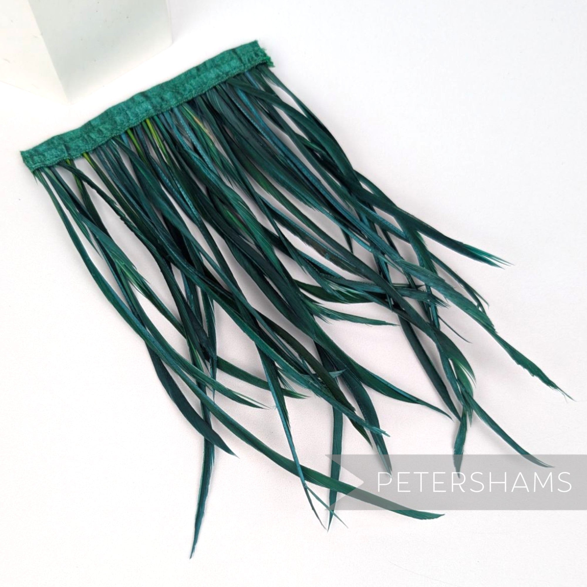 Petershams Millinery Supplies extra long bottle green goose biot feather fringe on a stitched satin binding