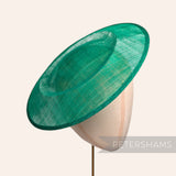 Petershams Millinery Supplies 29cm emerald green round sinamay fascinator hat base on a millinery head for fascinator making