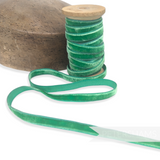 Petershams Millinery Supplies 10mm vintage green velvet ribbon on a wooden spool next to a millinery block