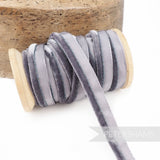 Petershams Millinery Supplies grey 5mm velvet insertion piping cord on a wooden spool for sewing and millinery