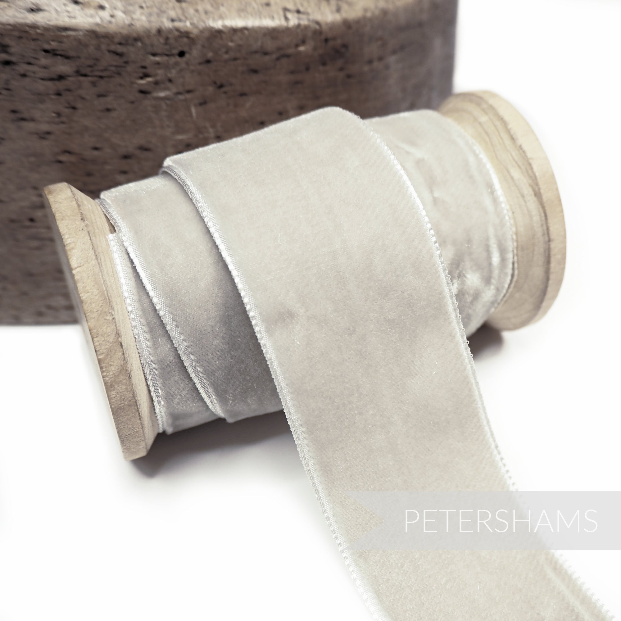 Petershams Millinery Supplies 36mm wide light grey French velvet ribbon on a wooden spool with a luxurious sheen.