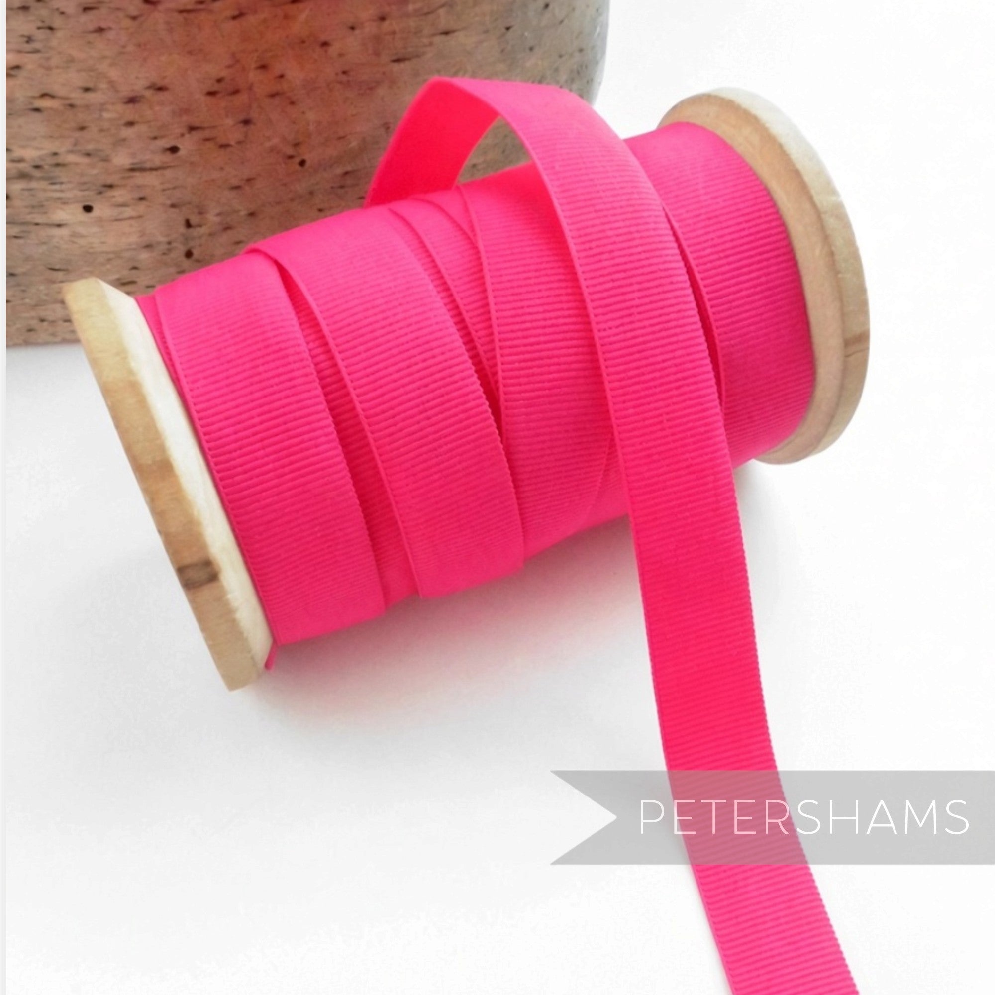 Petershams Millinery Supplies 15mm wide hot pink vintage grosgrain ribbon on a wooden spool for hat making.