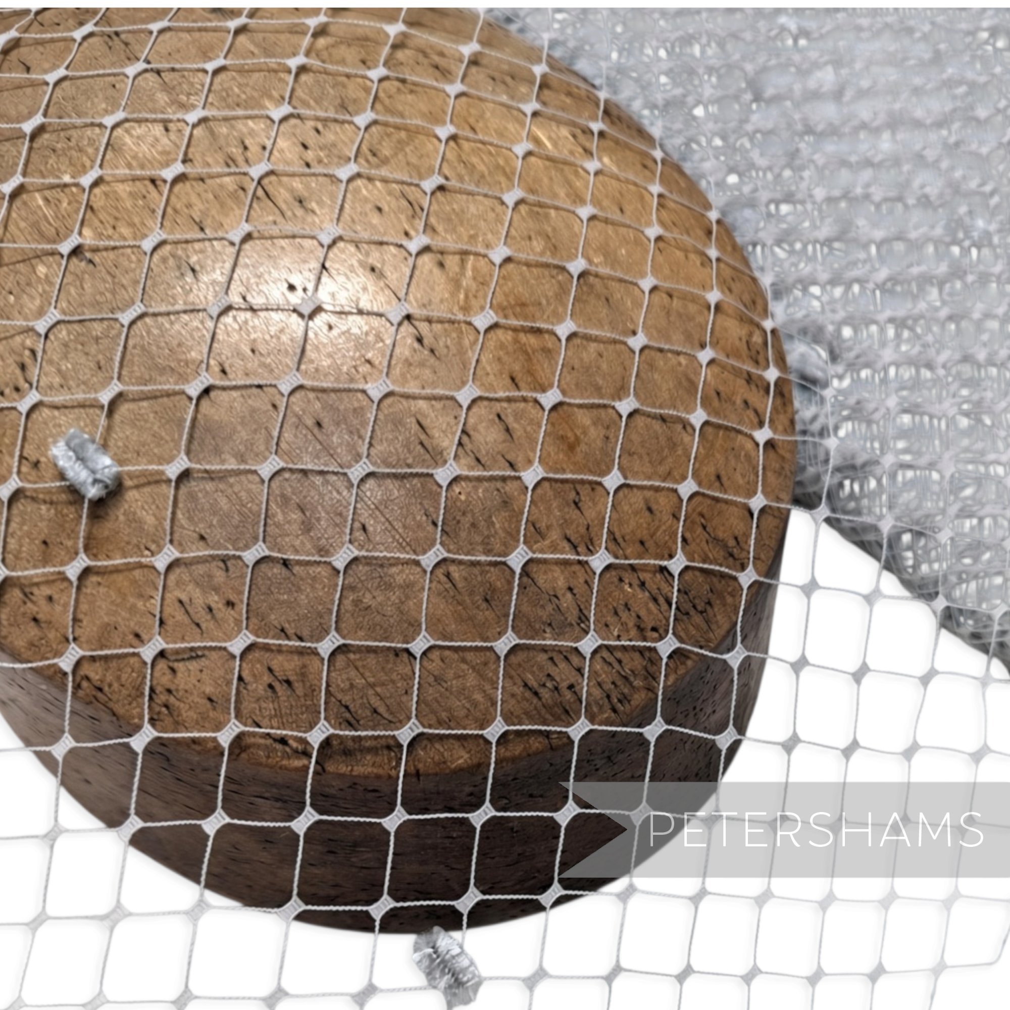 Petershams Millinery Supplies ice grey English Merry Widow veiling with chenille dots draped over a wooden hat block