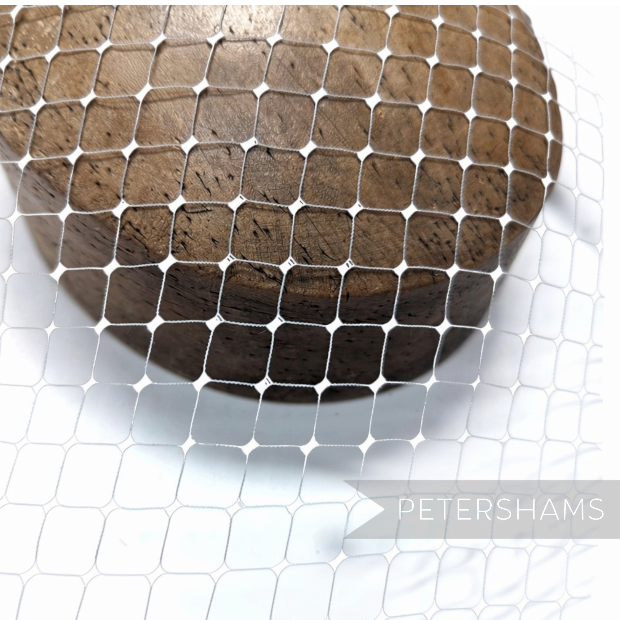 Petershams Millinery Supplies ice grey English Merry Widow veiling with chenille dots draped over a wooden millinery block