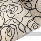 Petershams Millinery Supplies ivory jute-like cotton fabric featuring a black rose print for hat trimming