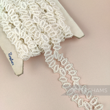 Petershams Millinery Supplies vintage 1950s ivory cotton guipure lace trim with a geometric horn scallop design.