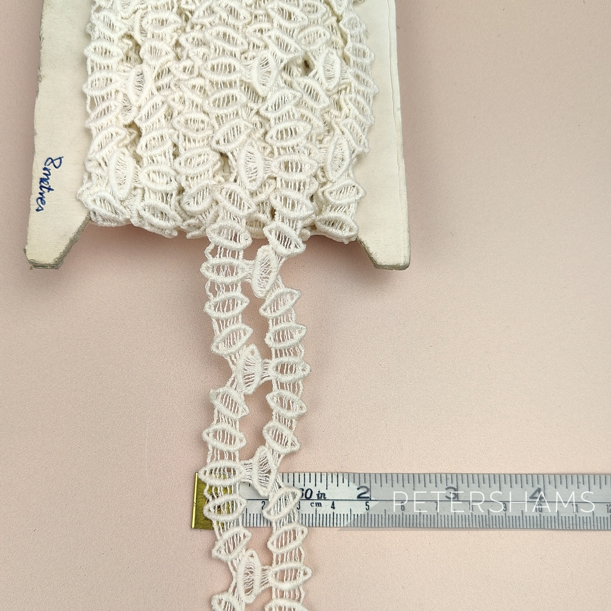 Petershams Millinery Supplies vintage 30mm ivory cotton guipure lace trim with a geometric horn scallop design.