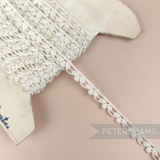 Petershams Millinery Supplies vintage 8mm ivory cotton guipure lace trim with a spotted club and swag pattern.