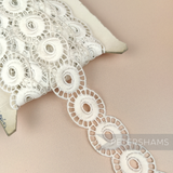 Petershams Millinery Supplies vintage 1950s ivory cotton guipure lace trim with an open whirl design on a spool.