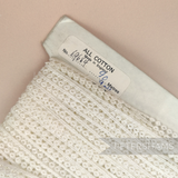 Petershams Millinery Supplies vintage 1950s ivory cotton guipure lace trim with doughnut pattern on a spool