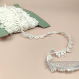 Petershams Millinery Supplies vintage ivory cotton guipure lace trim with a delicate grape bunch design.