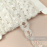 Petershams Millinery Supplies vintage 1950s ivory cotton guipure ribbon slot lace trim with a scalloped frame design.
