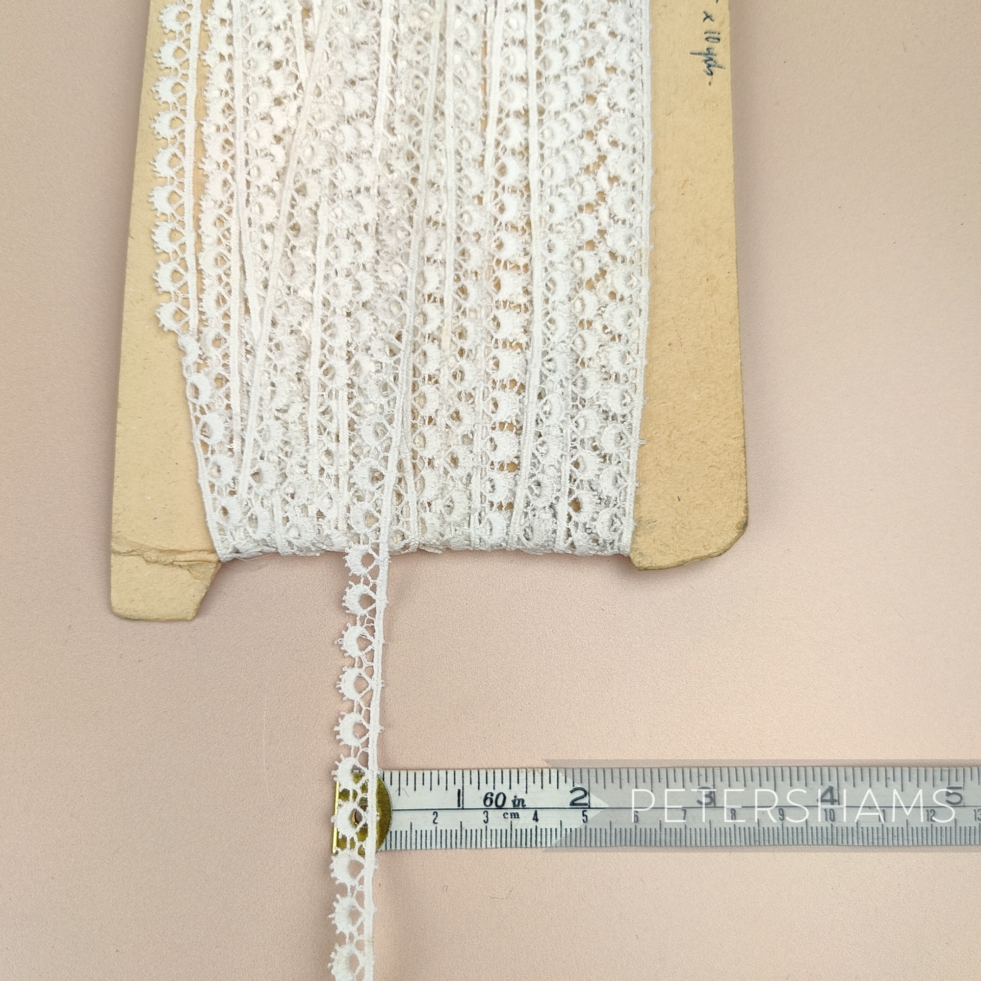 Petershams Millinery Supplies 10mm ivory cotton guipure lace trim with vintage eyelash peephole pattern on a card