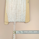 Petershams Millinery Supplies 10mm ivory cotton guipure lace trim with vintage eyelash peephole pattern on a card