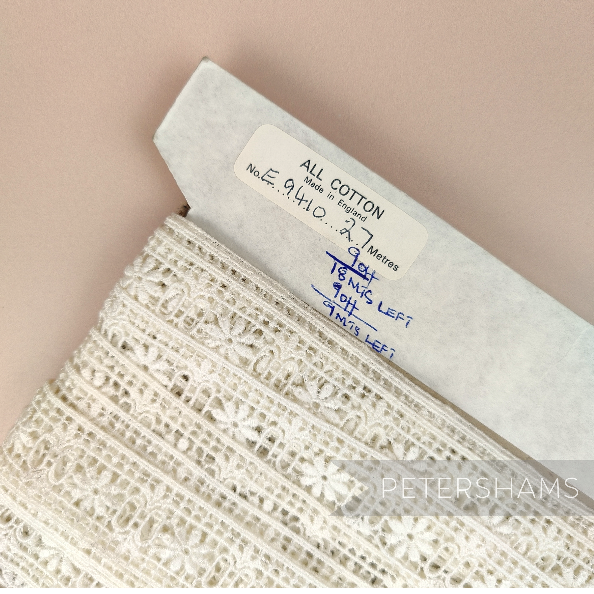 Petershams Millinery Supplies vintage ivory cotton guipure ribbon slot lace with grid flower pattern on a card roll.