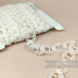 Petershams Millinery Supplies vintage ivory cotton guipure ribbon slot lace with a scalloped frame design.