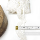 Petershams Millinery Supplies ivory 45mm guipure lace trim with a swag and twisted rope motif on a white background