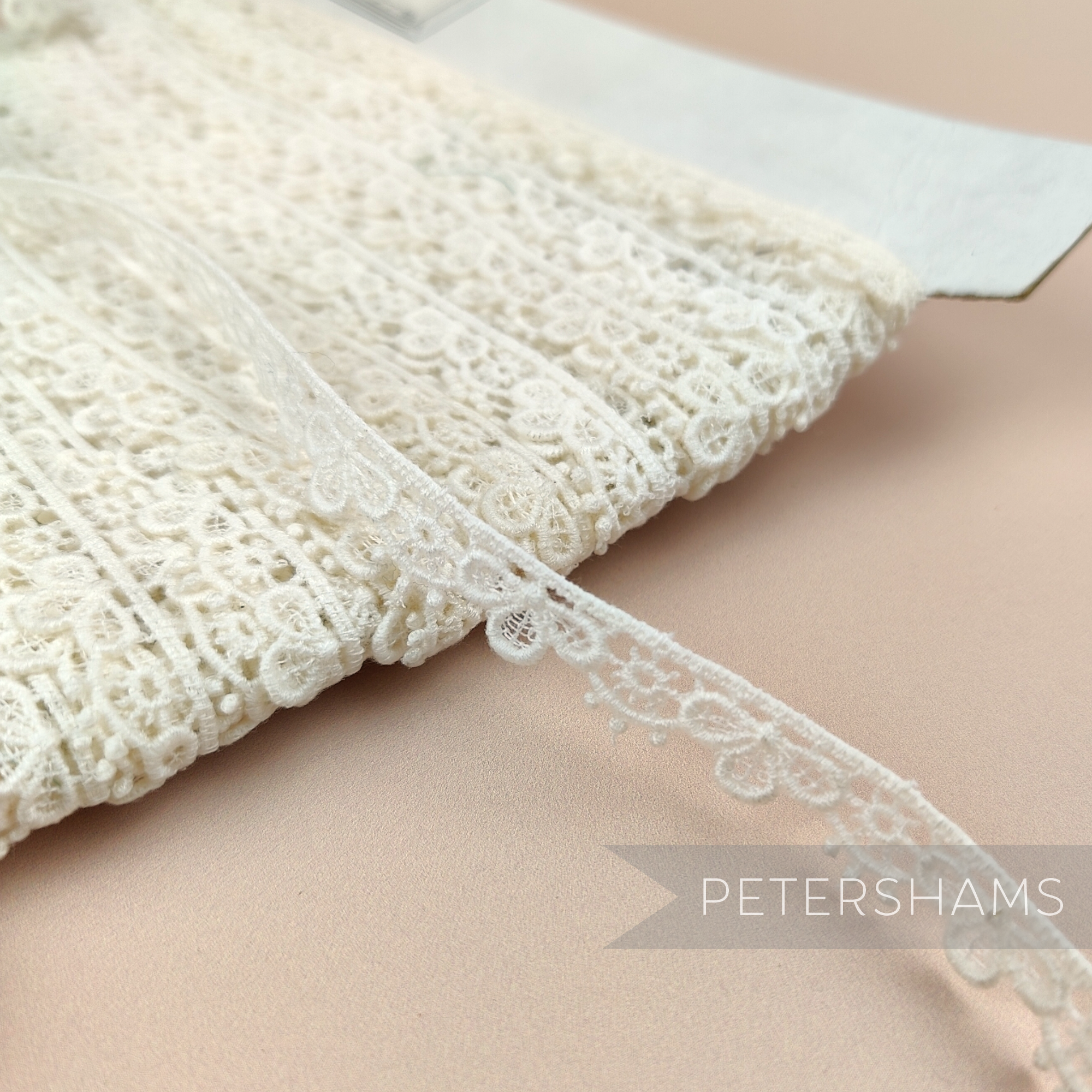 Petershams Millinery Supplies vintage 12mm ivory guipure lace trim with a delicate sunshine petal design.