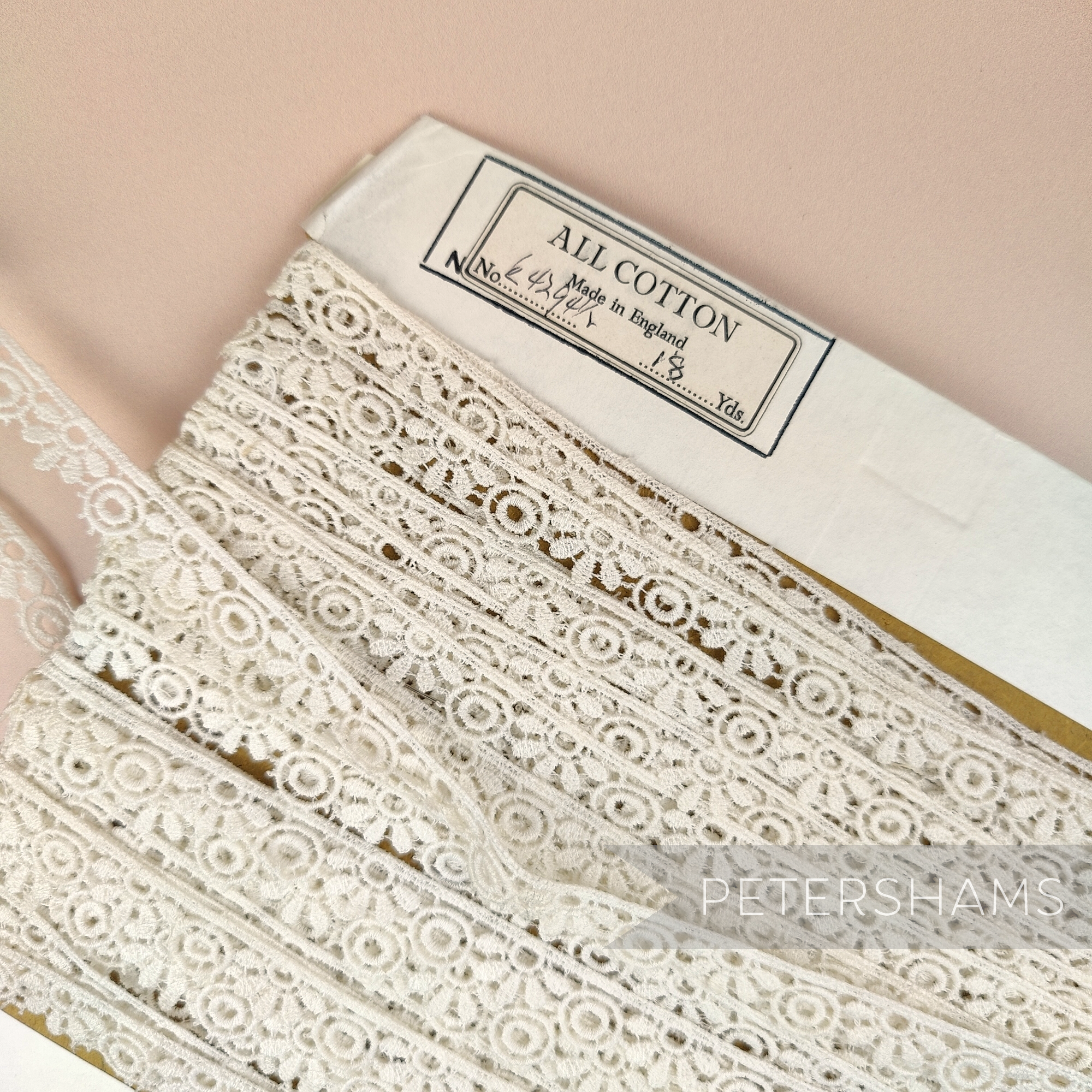Petershams Millinery Supplies vintage ivory guipure lace trim with a 12mm wide tumbling leaf pattern on a spool.