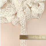 Petershams Millinery Supplies vintage 30mm ivory cotton guipure lace trim with a bold graphic flower pattern.