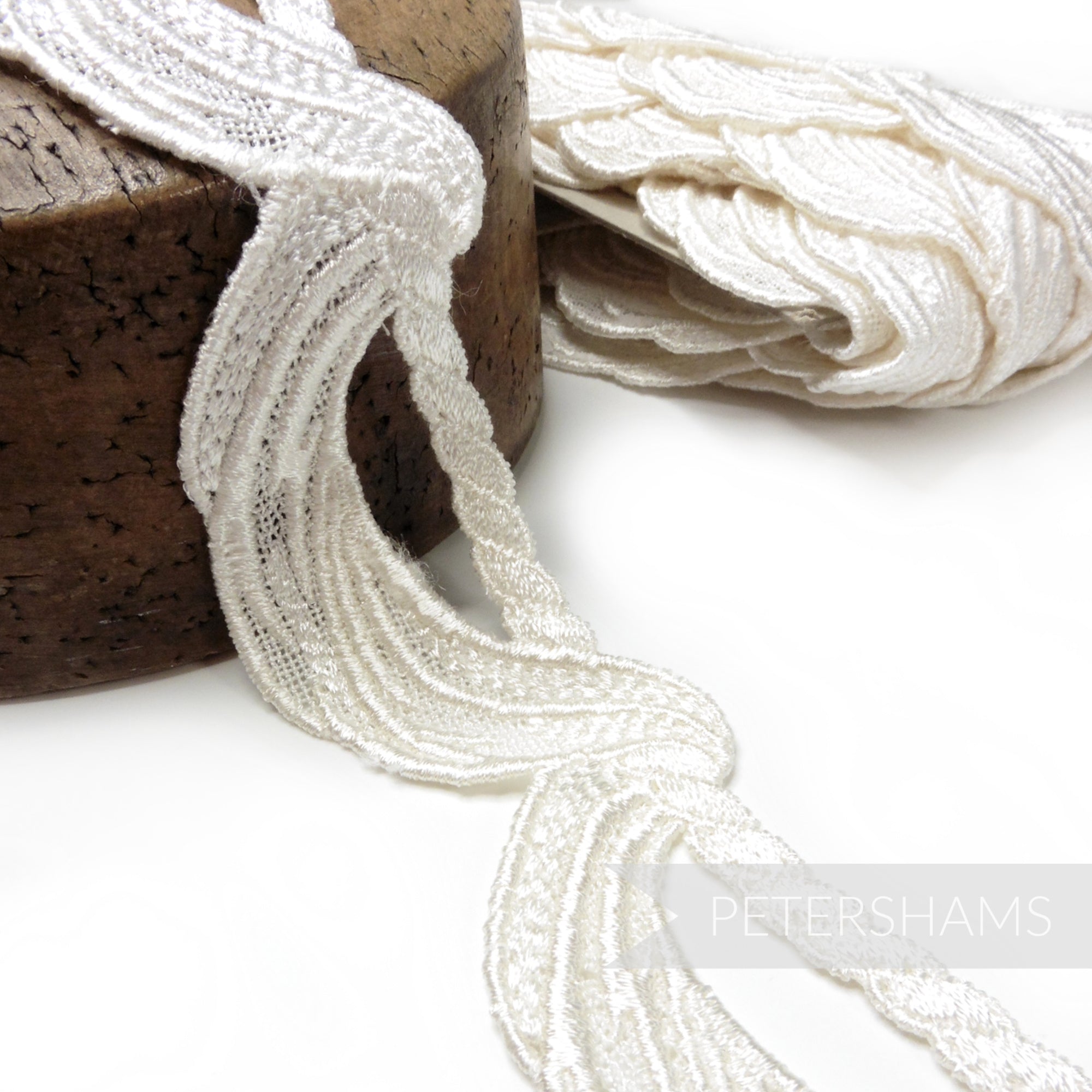 Petershams Millinery Supplies ivory 45mm guipure lace trim with a swagged twisted rope motif for bridal designs