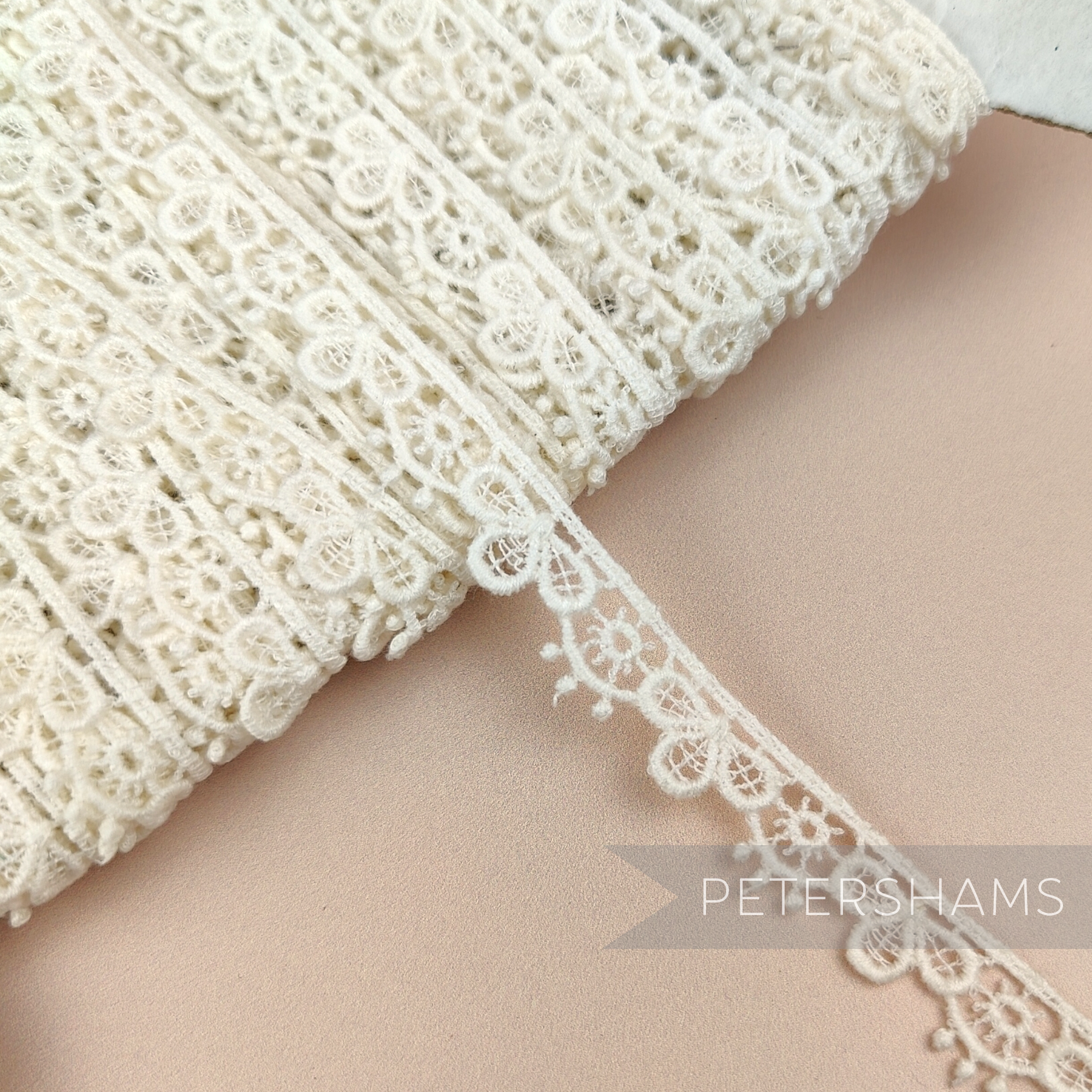 Petershams Millinery Supplies vintage ivory guipure lace trim with a delicate 12mm sunshine petal design.