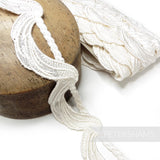 Petershams Millinery Supplies ivory 45mm guipure lace trim with a swagged rope motif on a wooden millinery block