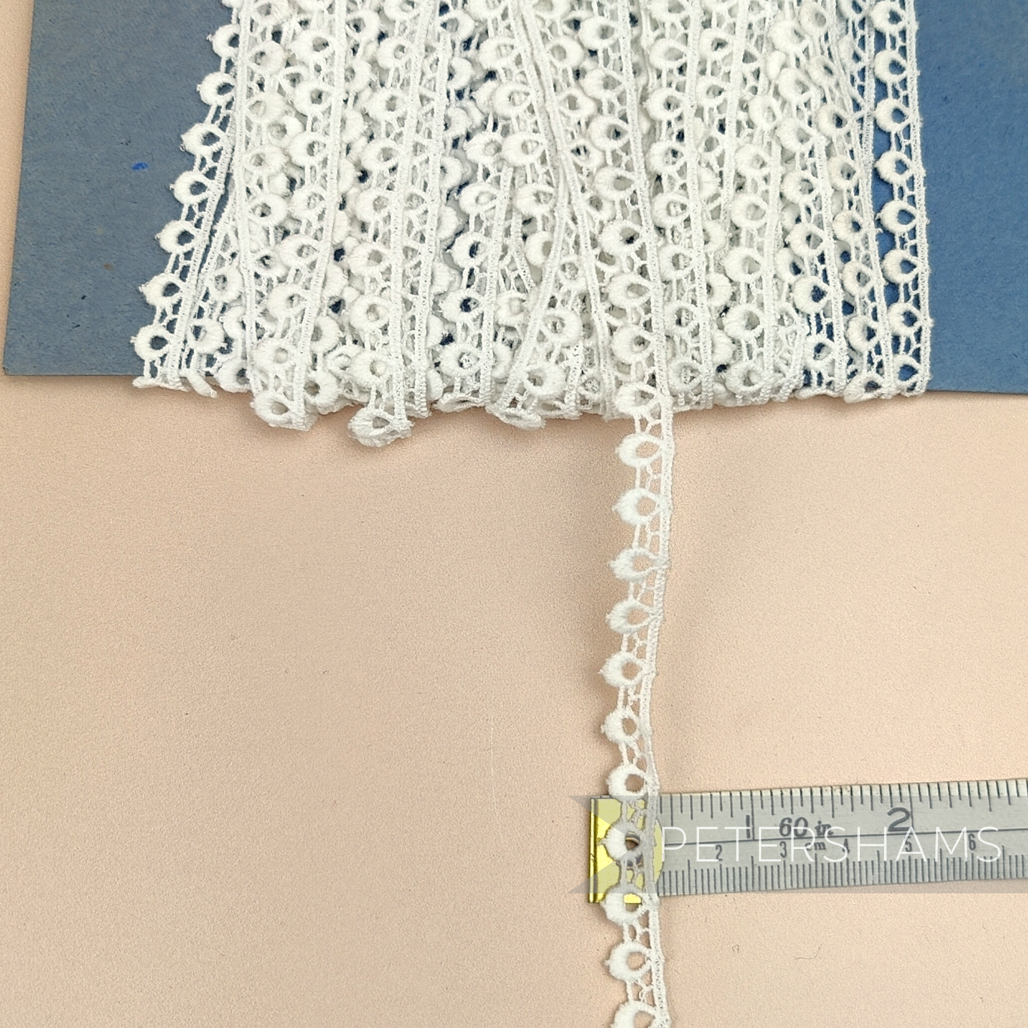Petershams Millinery Supplies vintage 9mm ivory cotton guipure lace trim with a delicate peephole scallop pattern.