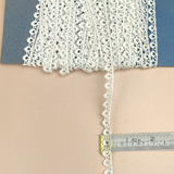 Petershams Millinery Supplies vintage 9mm ivory cotton guipure lace trim with a delicate peephole scallop pattern.