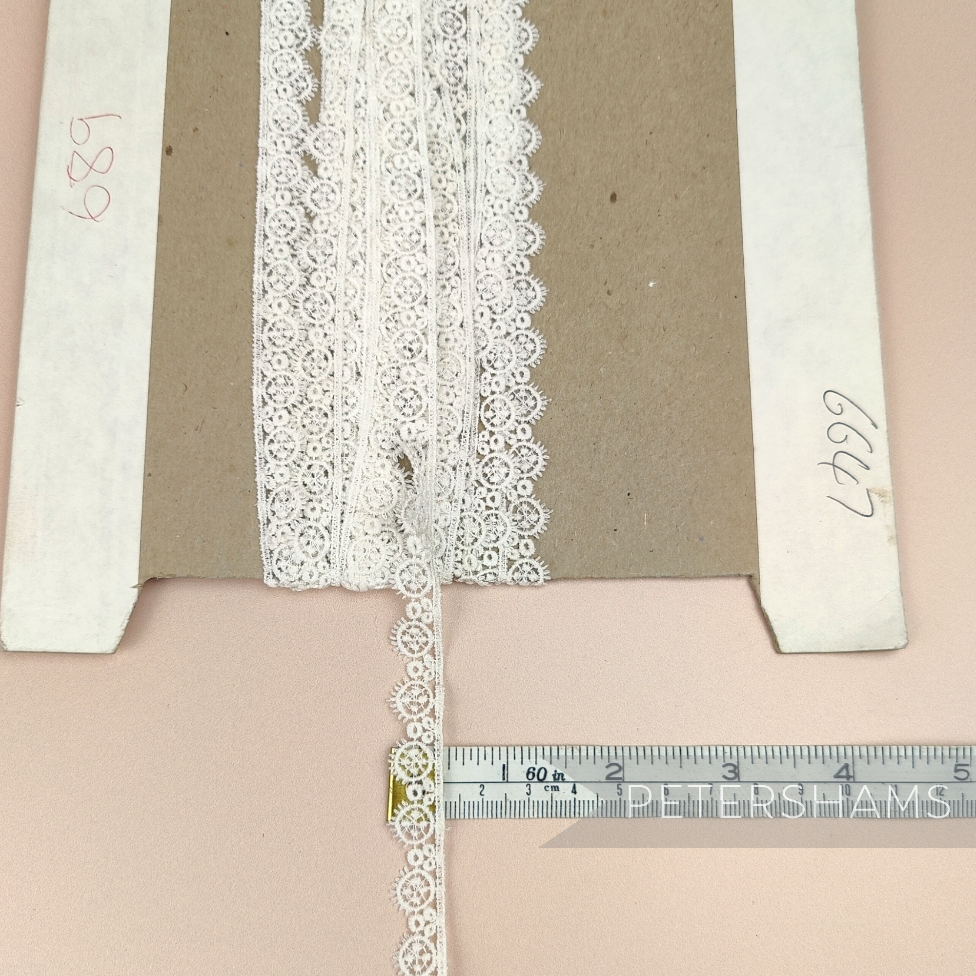 Petershams Millinery Supplies vintage 12mm ivory guipure lace trim with an eyelash wheel design on a cardboard spool.