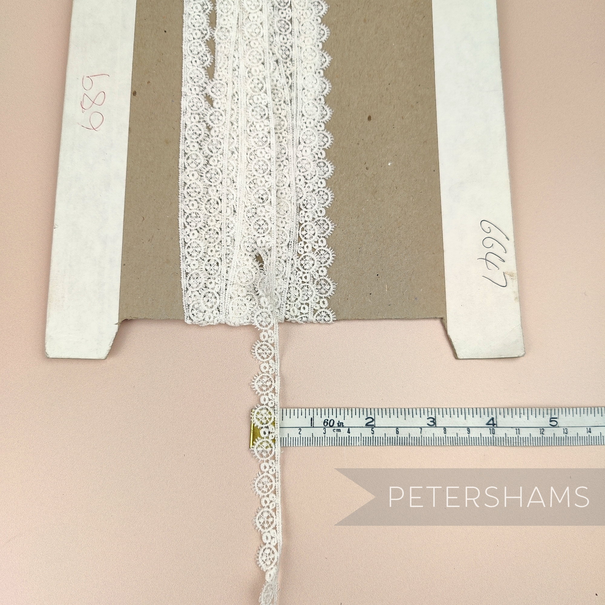 Petershams Millinery Supplies vintage 12mm ivory guipure lace trim with an eyelash wheel design on a cardboard spool