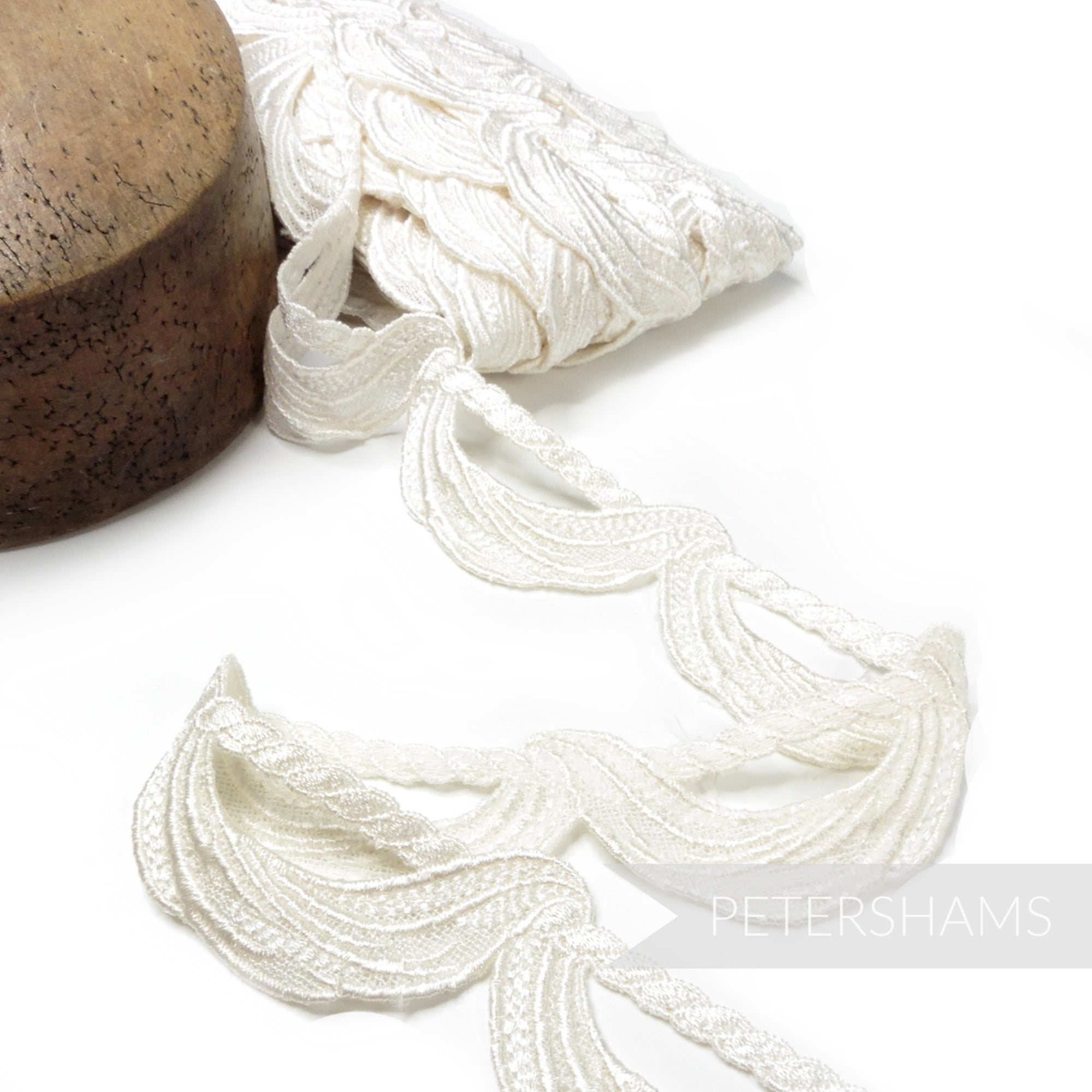 Petershams Millinery Supplies ivory 45mm guipure lace trim with a swag and twisted rope motif for bridal designs