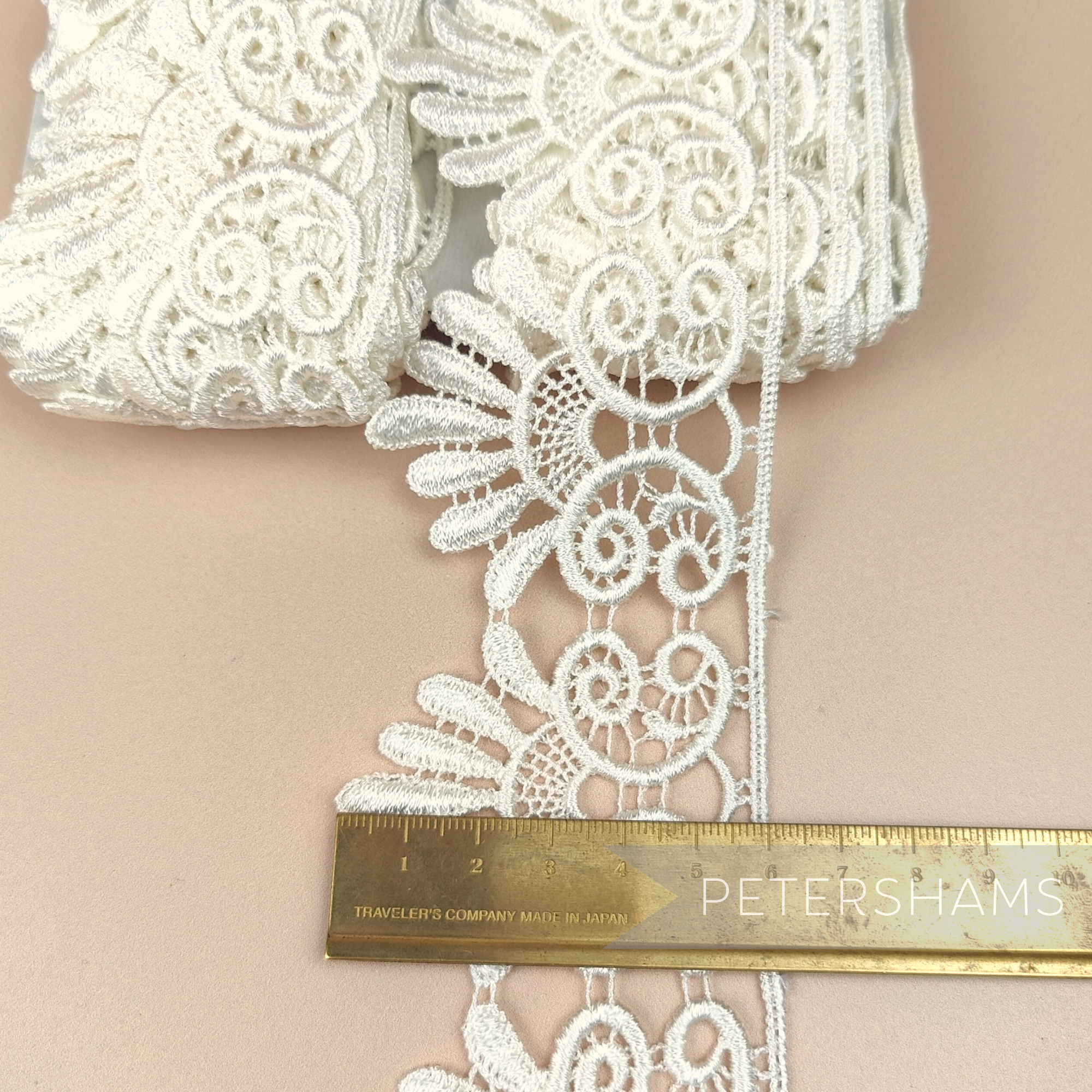 Petershams Millinery Supplies 6cm ivory guipure lace trim with a vintage-style filigree design on a neutral background