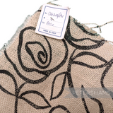 Petershams Millinery Supplies ivory jute cotton fabric with black rose print, ideal for hat trimming.