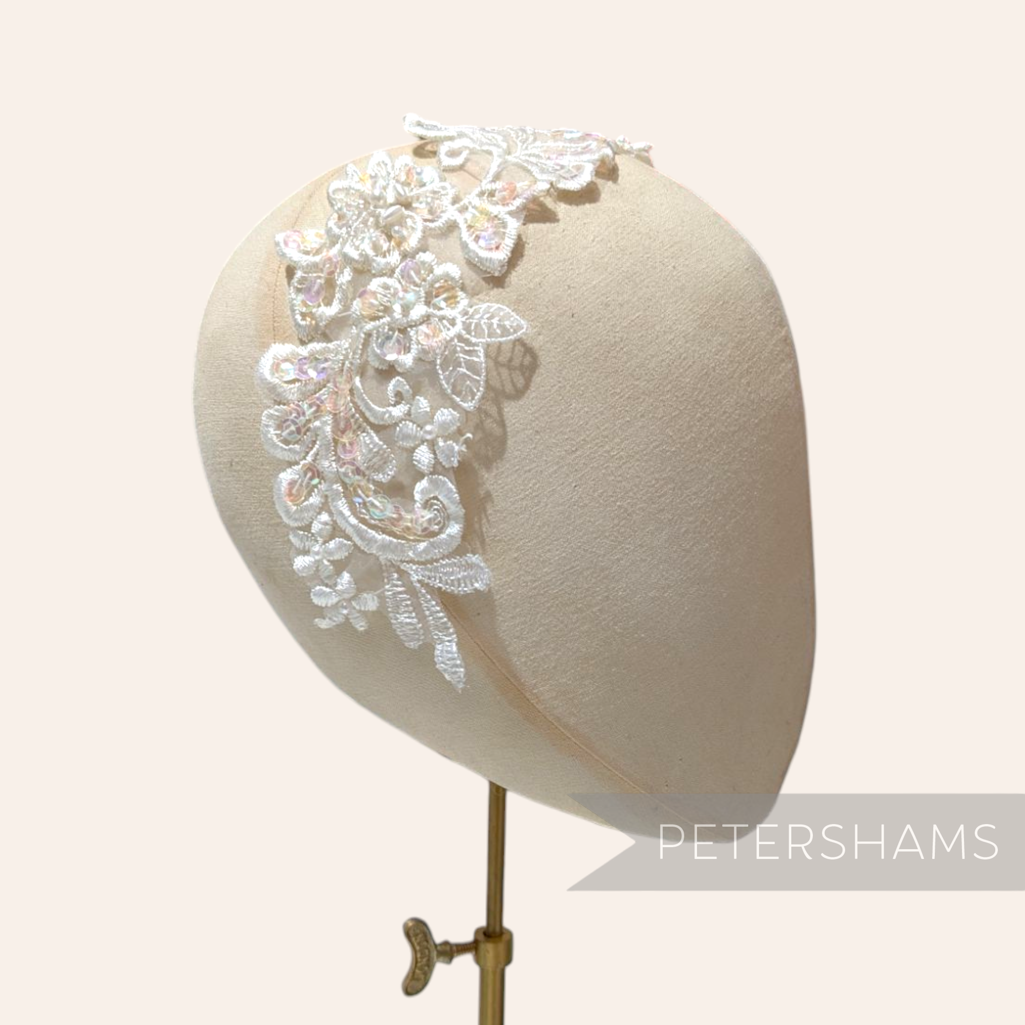Petershams Millinery Supplies ivory lace collar motif with iridescent sequins and faux pearls on a millinery head form
