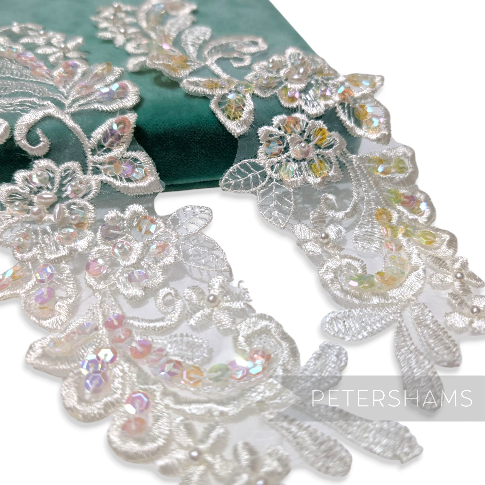 Petershams Millinery Supplies Gladys ivory lace collar motifs with iridescent sequins and faux pearls on green velvet.