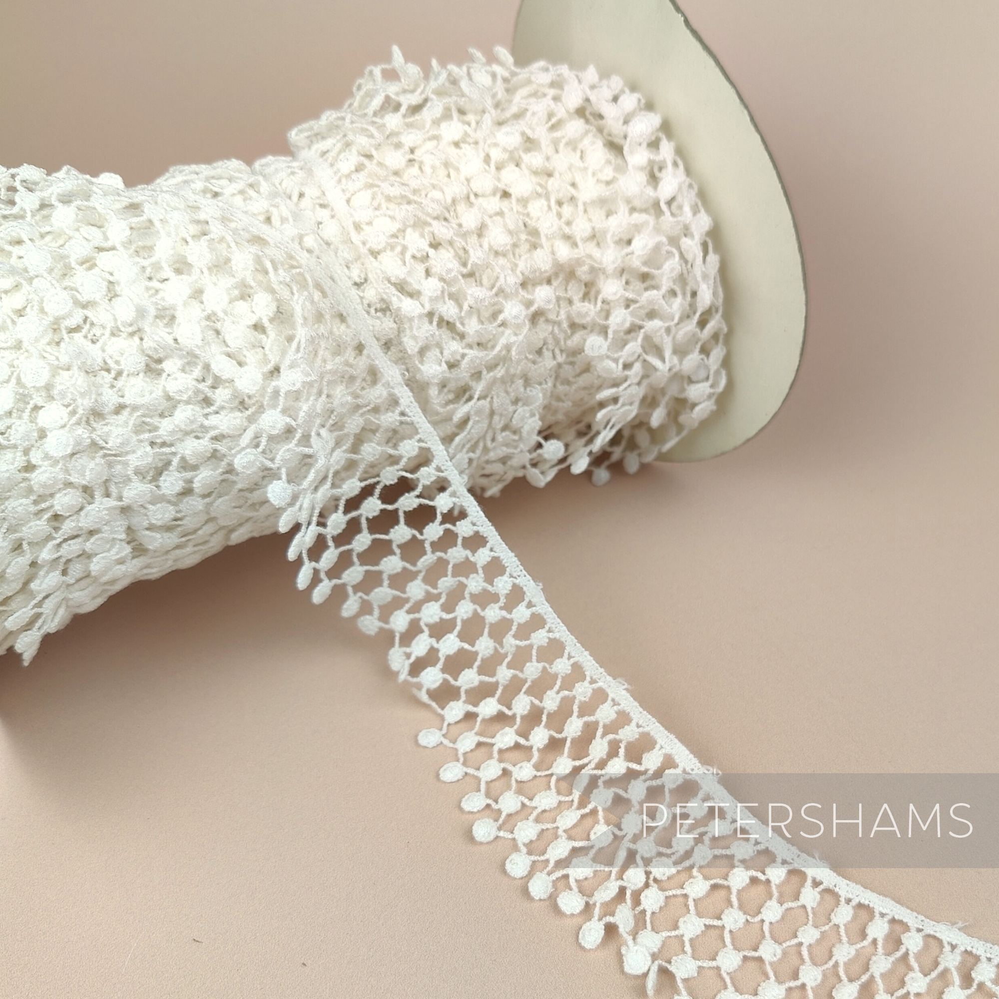 Petershams Millinery Supplies vintage 1960s ivory nylon guipure lace trim with a thatched ruffle design on a spool