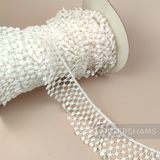 Petershams Millinery Supplies vintage 1960s ivory nylon guipure lace trim with a thatched ruffle design on a spool