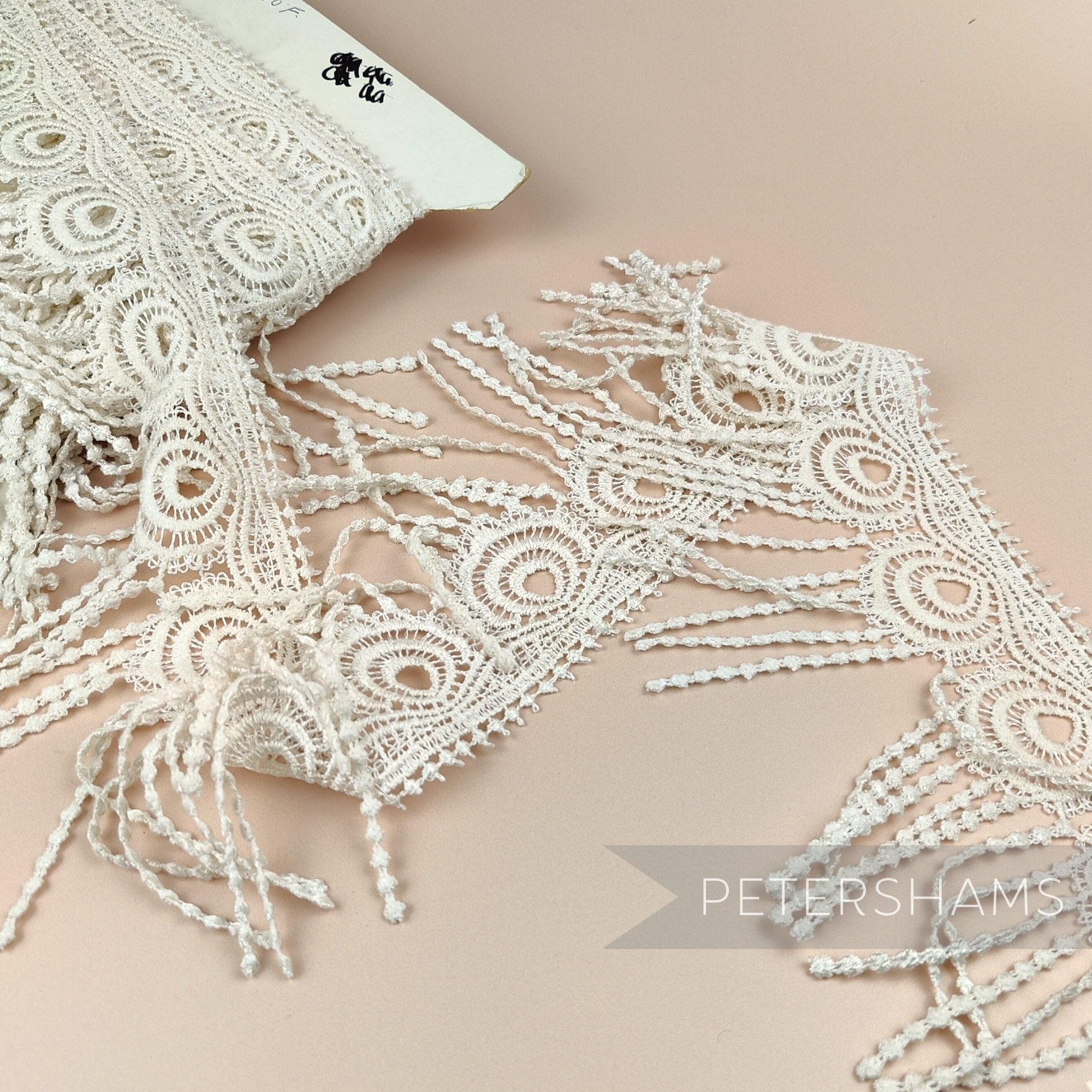 Petershams Millinery Supplies vintage 1990s ivory guipure lace trim with a 12.5cm wide peacock feather fringe design.