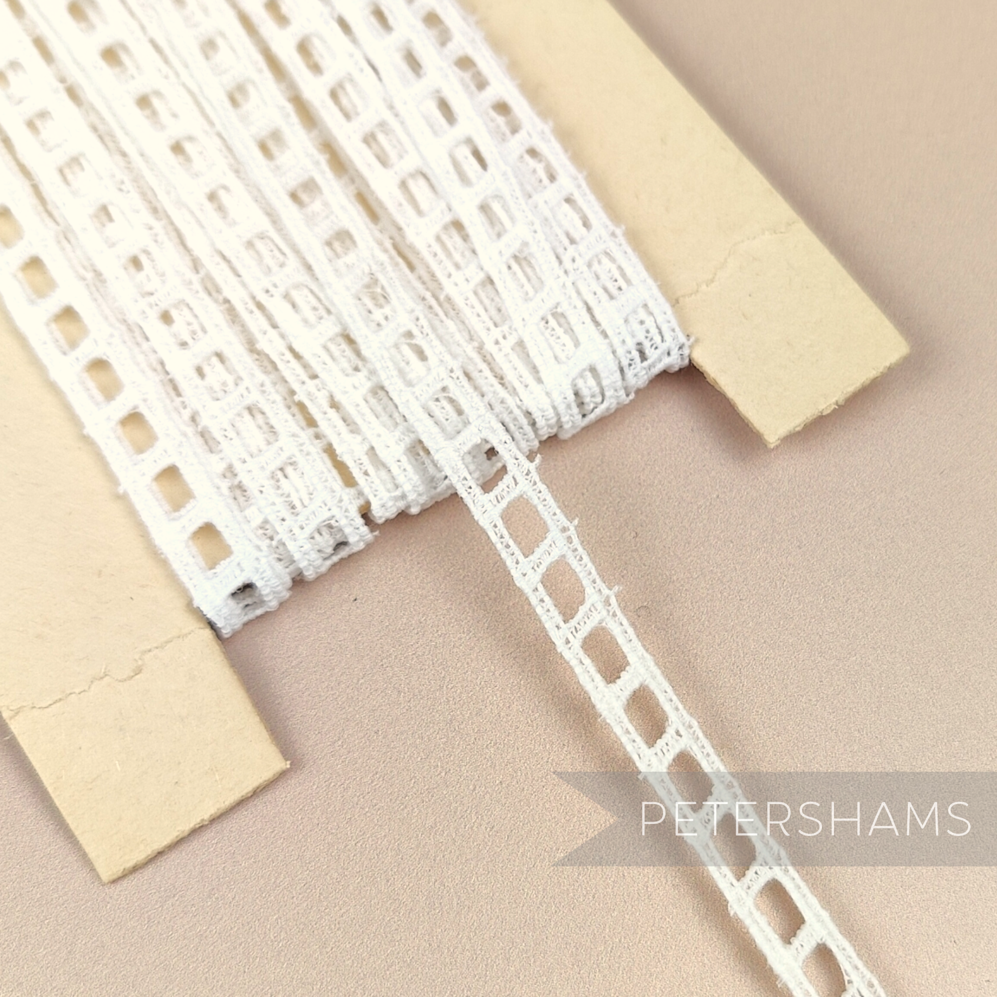 Petershams Millinery Supplies vintage 7mm ivory cotton ribbon slot lace on a card for sewing and craft projects.