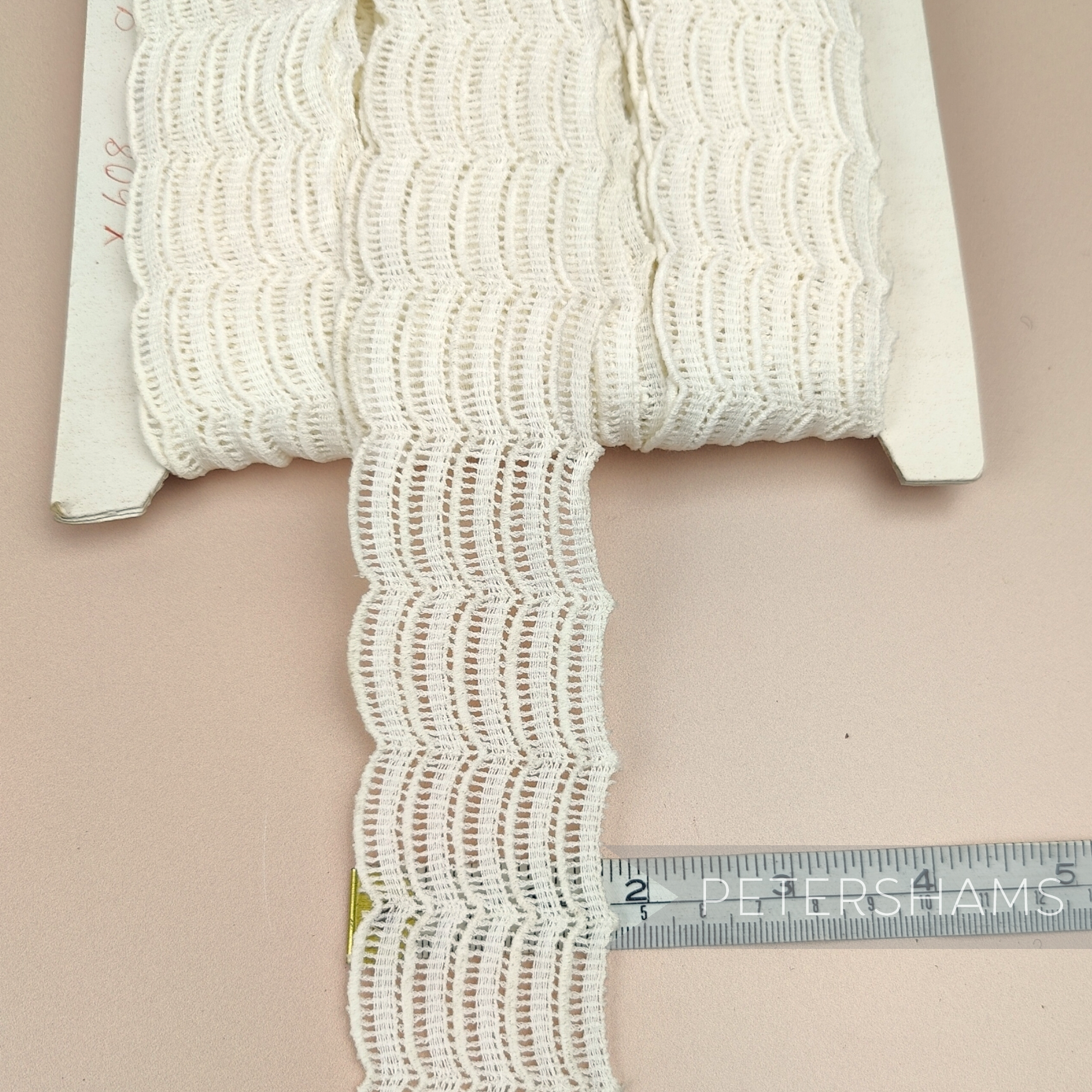 Petershams Millinery Supplies vintage ivory cotton guipure lace trim with a fine woven wave pattern on a spool.