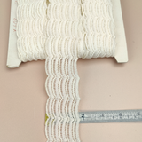 Petershams Millinery Supplies vintage ivory cotton guipure lace trim with a fine woven wave pattern on a spool.