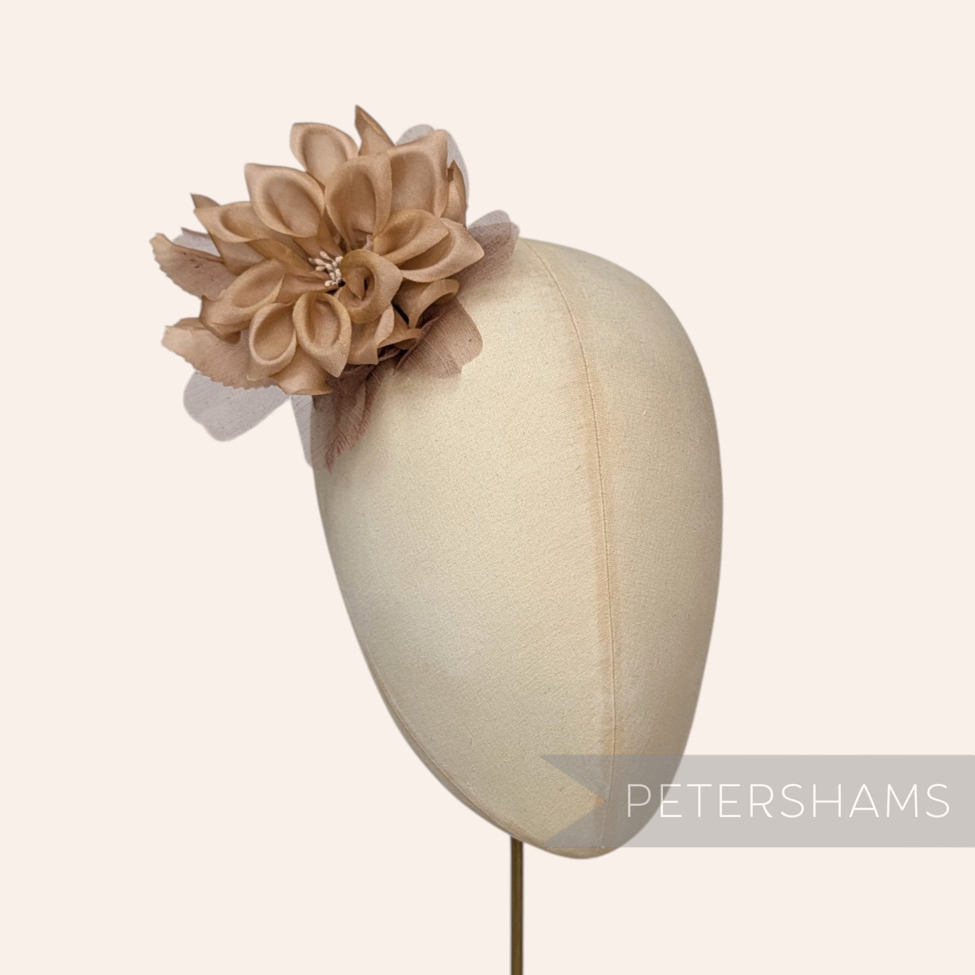 Petershams Millinery Supplies Dilliah latte silk and organza dahlia flower hat mount on a millinery head block