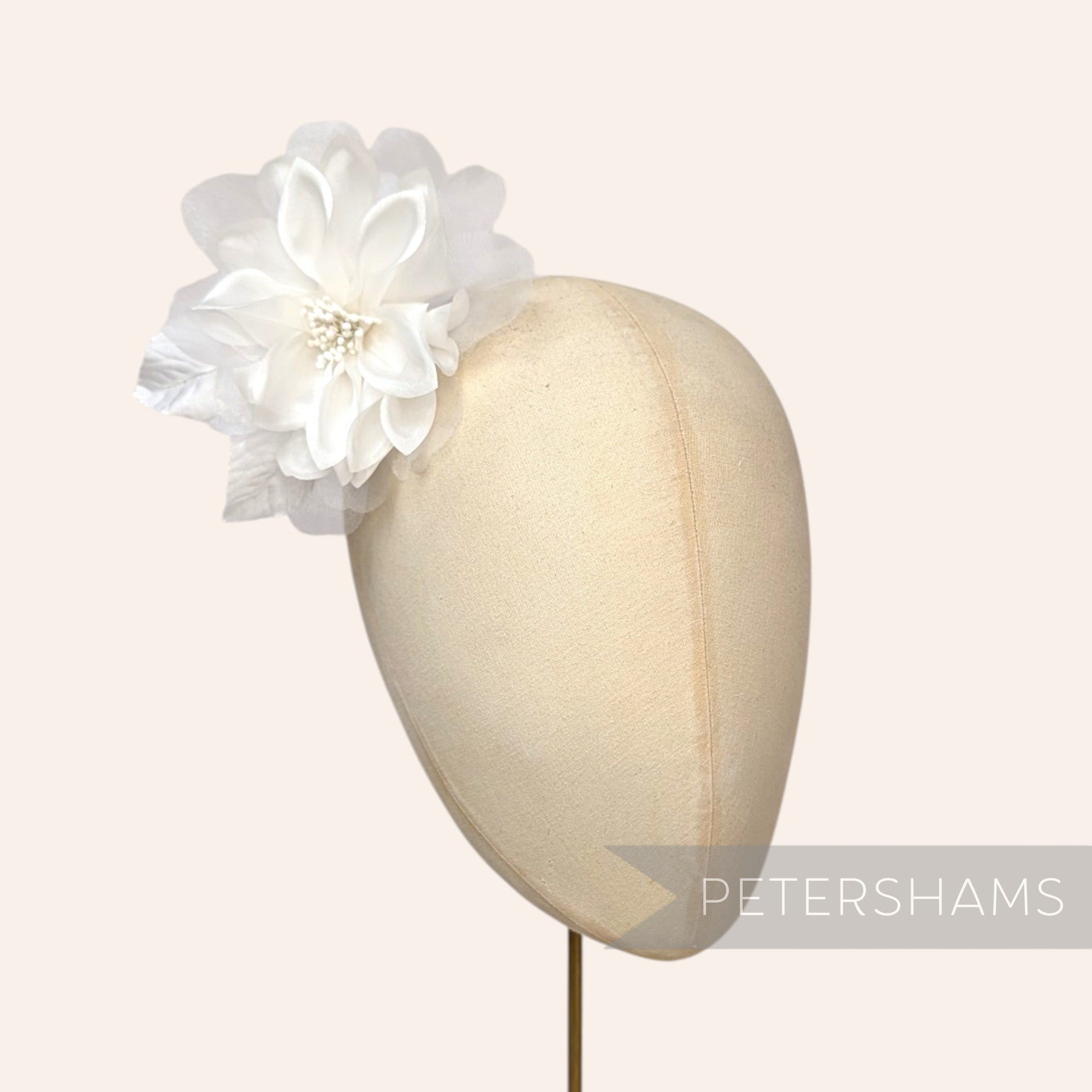 Petershams Millinery Supplies Dilliah latte silk and organza dahlia flower hat mount on a millinery head block